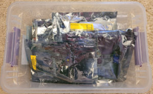 Plastic tub containing lots of PC expansion cards in anti-static bags.